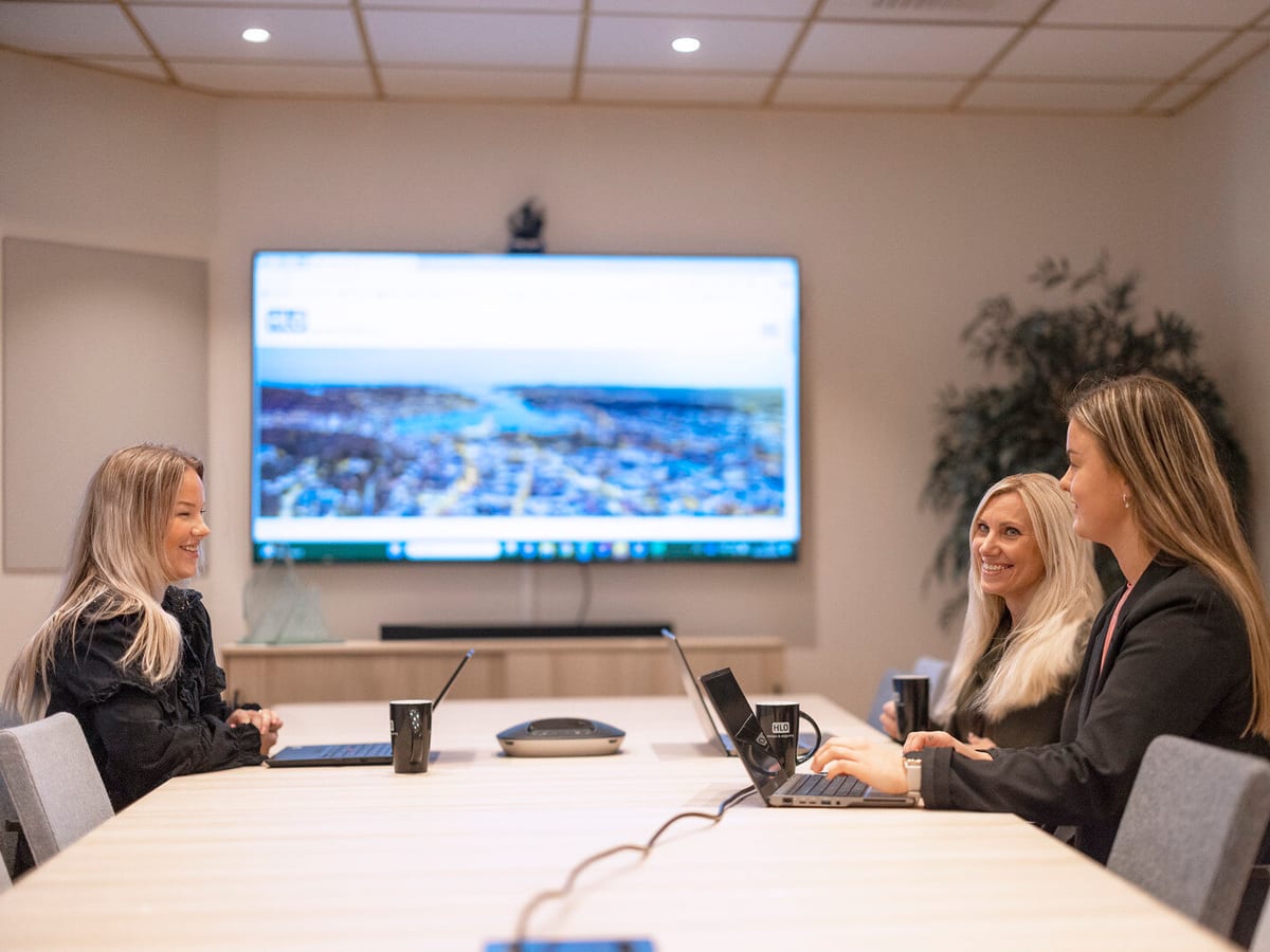 Ansatte i HLO Revisjon i et møterom